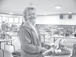 Photo by Sandra Hyne Irene Malner of the Grand Marais Lioness Club is active in the community in many ways, including being a participant in the Cook County Fair. She is pictured here with her award-winning raspberries.