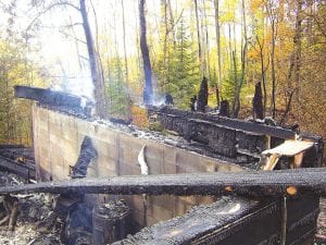 Staff photo/Jane Howard No injuries were reported. The next day, red coals were still glowing and smoke was still rising from the ashes.