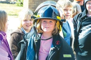 Photos courtesy of Birch Grove Community School The Tofte Fire Department visited Birch Grove Community School on Friday, October 9 to talk to students about fire prevention and safety. Above: Jordyn Bjerkness tries on a fireman’s helmet—it’s heavy! Right: Kasey Johnson takes a turn at the hose with Tofte firefighter Sam Crowley. Tofte firefighters Rich Nelson, Dave Rude, Lester Smith, and Darren Peck also took part.