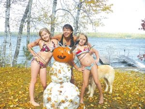 Photo by Lisa Wahlers The Devil Track Lake polar bear club? The early season snow on Saturday, October 10, did not deter these young ladies from their sunbathing! The girls used up all of the approximately 1 ½-inches of snow that fell in their Devil Track Lake yard and used a pumpkin for the snowman’s head. (L-R) Morgan Weyrens-Welch, Isabelle Wahlers, and Reilly Wahlers. Brrrr!