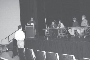 Staff photo/Rhonda Silence Cook County Auditor Braidy Powers steps up to the microphone to answer a question at the WTP Public Forum at the Arrowhead Center for the Arts on Tuesday, October 13. Moderator Jay Andersen of WTIP and panel members Sue Prom and Sue Davies listen to his response.