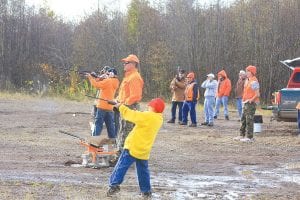 Above right: Shooters lined up to take aim at paper, clay pigeon, and steel silhouette targets.