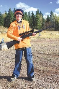 Above left: Owen Anderson displays the deer rifle he won in the drawing at the Cook County Sportsmen’s Club event.