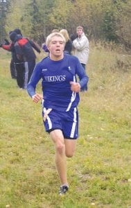 Left: Drew Holmen finished sixth in the boys’ varsity race in 19:09, clinching all-conference honors, along with David Bergstrom who finished fifth.