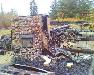 Left: The scene at Gunflint Lodge units 26 and 27 after a fire destroyed the duplex cabin in the wee hours of Friday, October 23, 2009. Above: Gunflint Trail firefighers remained on scene until the early morning hours. The fire started in a fireplace chimney while guests were sleeping. Everyone made it out safely, although some lost their belongings.