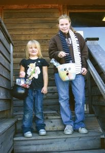 Left: Sadie Wilson, 6 and Libby Zafft, 12, with their buckets of Halloween toys and treats. Top: Grace Ritchey, 4, checks out the amazing kaleidoscope donated by The Attic, that was in her Halloween bucket.