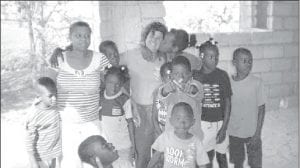 Photo courtesy of EWI Kathy Roe of Grand Marais (center) is fulfilling a lifelilng dream of helping the children of Haiti with the charity On Eagles Wings