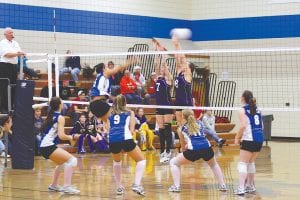 Left: The hard-hitting Viking girls hammered the ball at the Albrook Falcons at the game at Hermantown on Friday, October 30. The Vikings defeated Albrook in three to continue their progress in playoffs. (L-R) Ashley Deschampe, Christina Nelson at the net, Brea Boomer, Bekah Laky, Kristina Rude. Above: The volleyball team had some high-spirited cheerleaders—the Gentlemen Vikes!— entertaining the crowd between the action.