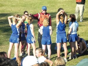 Cook County Viking runners and fans traveled to St. Olaf College in Northfield on Saturday, November 7 for the Minnesota State championship meet. Left: The girls’ team excitedly checking in with a Minnesota State High School League official before their race at St. Olaf College. Above: Recovering from the flu, Kieran Scannell finished his race in 18:57 for 134th place in the 160-runner field.