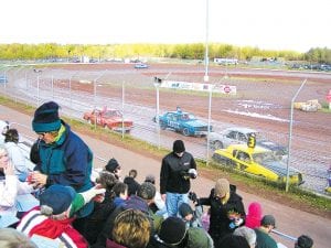 On the track are local racers, Rick Backstrom in the turquoise IXVIII car and Nick Pitman in orange number 87.