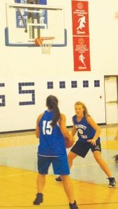 The Viking girls kicked off the basketball season on Monday, November 16 with a “Midnight Madness” version of basketball practice. Top: Basketball Coach T.J. Super shows off a defensive position. Above: Brea Boomer practices defense against Christina Nelson.