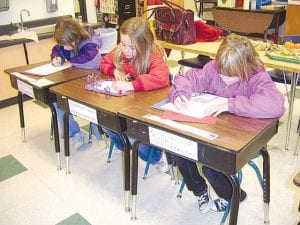 For Veterans Day Wednesday, November 11, 2009, Sawtooth Elementary second graders wrote letters thanking veterans for their service to our country. They were displayed at various locations throughout Grand Marais. Pictured (L-R): Abbie Crawford, Bianca Zimmer, and Jaymie Kirk.