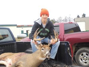 Michael Sjogren, 15, of Grand Marais with his 13-point buck. The buck was 205 pounds and had a 17 inch rack.