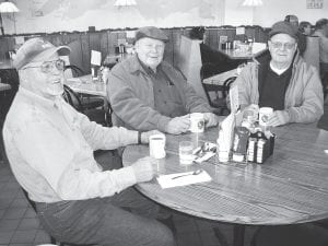 On the minds of people out for coffee the morning of Monday, December 7, 2009 were hopes of being with family over Christmas, the joy of giving, and thankfulness for loved ones. Photos top to bottom: (L-R) Chuck Soderholm, John McElevey, and Leonard Goodell at Blue Water. Yvette Chenaux (left) and Alisa Berns working on Christmas secrets at Java Moose. (L-R) Sarah K. Bly holding Jeremiah Bly and Sarah E. Bly holding Josiah Bly at Blue Water. (L-R) Father Seamus Walsh, Pat Randall, Rita Randall, and Mary Langer at Blue Water. Paul Nelson (left) and Karl Hansen at Java Moose.