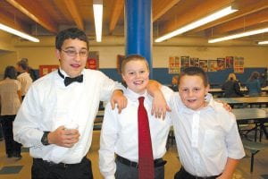 The Cook County Middle/ High School band concert was a holiday treat for community members who filled the gym the evening of Monday, December 14, 2009. Above: (L-R) Daniel Ditmanson, Lars Scannell, and Frankie Miller were in high spirits after the concert. Left: High school and 7th and 8th grade band director Bill Tormondsen with Sterling Anderson.