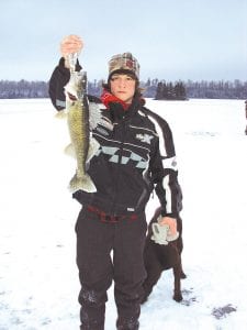 Left: Ben Larson of Grand Marais, home for a visit from Central Lakes College in Brainerd, enjoyed a day of fishing at an undisclosed lake. He is pictured with his 20.5-inch walleye, which came out of the hole with its gills and fins frozen. Right: Ben’s friend, Zack Anderson, joined him and also saw success with this 20.5-inch walleye. Both young men are entering their last semester at Central Lakes College. Both are enrolled in the Natural Resources program.