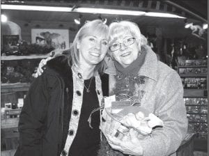 Staff photo/Rhonda Silence Lisa Wahlers (left) nominated her mom, Diane Hagen, to be recognized as an exemplary community member. The Lake Superior Trading Post honored Hagen with a Frasier Fir gift basket from The Thymes Company.