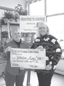 Photo courtesy of Salvation Army Mary Sanders (left) coordinator of the Salvation Army Red Kettle campaign, gratefully accepts “the largest ever” check from Cathi Williams, president of the Bethlehem Lutheran Church Women. Donations to the Red Kettle campaign assist local people in need throughout the year.