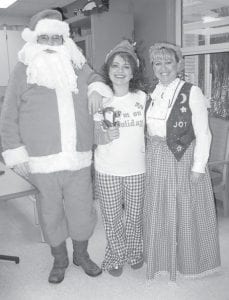 Above Left: Santa and Company put on a great Christmas Eve Party at the Care Center. (L-R) Santa Tim Styles, Elf Shannon Burgoon and Mrs. Claus Monica Houglum. Upper Right: Dan Helmerson and his mom, Donna, enjoyed being together for the Christmas Eve party at the Care Center. Above Right: Residents at the Care Center received gifts from their secret pals this Christmas. Sierra Parsons, nursing assistant, sits with Marion Buckman. Sierra was Marion’s secret Santa and she gave her this cuddly holiday blanket.