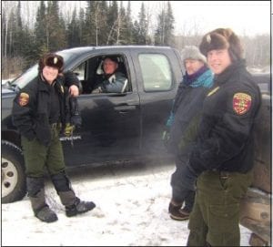 Staff photo/Jane Howard Left: Cook County’s DNR conservation officerswere ready to meet the cold during the training at the old Devil’s Track Airport. (L-R) Conservation officer (CO) Mary Manning, CO Darin Fagerman, volunteer instructor Kim Linnell, and CO Tom Wahlstrom.