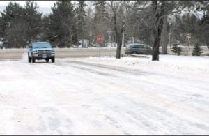 City streets and side roads throughout the county are treacherous after the rain and snow mix that fell on Christmas day. Right: Earl Anderson of Maple Hill gingerly makes his way to the Grand Marais Senior Center.