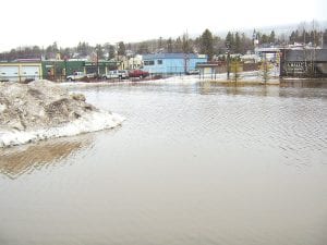 First it rained, then it snowed in Grand Marais Sunday, January 24, 2010, after a weekend of thawing temperatures. Overall, precipitation for the winter has not been significant, with snowmobilers and skiers waiting week after week for more snow. The rain and melting snow were enough, however, to flood the municipal parking lot on Broadway Avenue. The water was about two feet high in places.