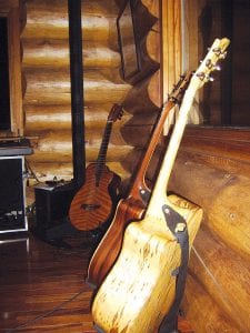 Musician Michael Monroe and his wife and manager, Deb Mueller, have been hosting a log cabin concert series in their home on the Pike Lake Road. They combine food, companionship, and beautiful music in the restful setting of the North Woods. Guests range from neighbors to people who come from far away to enjoy an evening of warm hospitality. Above: These are some of Michael Monroe’s guitars, handcrafted by Dave Seaton of the GunflintTrail. It’s amazing to realize that North Woods trees can produce these beautiful tiger stripe and birds’ eye patterns.