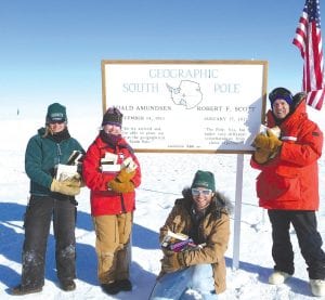 Below: Gunflint locals Elissa Grammling, Susan Weber, Thano Syroponlos and Beaner Cohen at the Geographic South Pole with the book donations for the Grand Marais Library. Left: Upon arrival in Grand Marais Linda Chappell, Mike Schelmeske, and Helen Muth excitedly unpack the 