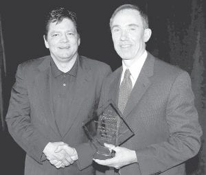 Grand Portage Enterprise Administrator Steven Standing Cloud (left) accepts the Competitive Travel Marketing Award at the Explore Minnesota award dinner at Cragun's Resort in Brainerd in January. Presenting the award is Explore MN's John Edman.