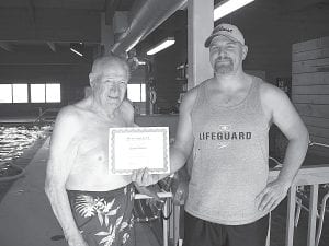 Upon the recommendation of staff at its Tuesday, February 2, 2010 meeting, the Grand Marais Park Board voted to give free pool memberships to anyone 100 years old or older. The pool has one regular patron who meets the requirement – Gunnar Erickson -- and he has been buying pool passes since the pool opened over three decades ago. Head Lifeguard Charles Christiansen wasted no time presenting Erickson with an “Over 100 Club” certificate authorizing free pool membership for life. Pictured here during the morning adult swim on February 3 are Erickson (left) and Christiansen. Last November Erickson turned 101.