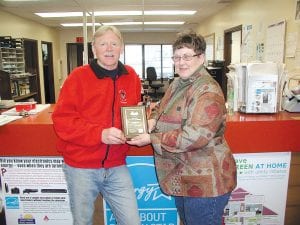 Grand Marais Public Utilities Secretary Jan Smith presents an award to Buck Benson of Buck’s Hardware for his participation in the “Change a Light, Change the World” campaign sponsored by Grand Marais Public Utilities and the U.S. Environmental Protection Agency. The campaign encouraged Grand Marais Public Utilities customers to save money, energy and the environment by replacing their energy guzzling incandescent bulbs with more efficient compact fluorescent lamps (CFLs). The city is seeking two grants to improve its overall energy efficiency.