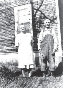 Gloria Martineau shared this photograph of her grandparents, Lois and Sam Linnell, standing in front of their homestead, which used to stand on County Road 14. Martineau remembers that her grandmother always wore an apron. She also remembers that her grandparents raised pigs. The old building is gone now, but it has been immortalized in a number of paintings. She said artists frequently stopped to paint the lovely homestead scene.