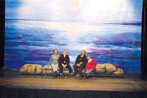 This beautiful ocean painting will be the backdrop for the Grand Marais Playhouse production of Treasure Island which opens April 22. Seven local artists painted for 10 days to create this 18-foot by 26-foot painting. Pictured are Gina Macy, Emily Ulhorn, Jan Attridge and Beth Olson. (Not Pictured: Kurt Anderson, Gerry Grant and Sue Hennessy)