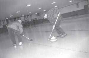 This 1999 photo taken at the Cook County Curling Club features Cook County News-Herald staffer Brian Larsen showing his curling skills. Sweep, Brian, sweep!