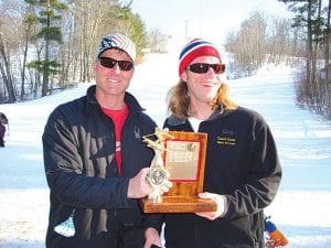 Team Lutsen Coach Charles Lamb and Team Duluth coach Dave Zbaracki pose with the championship trophy.