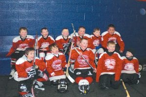 The Cook County Mite 1 team finished the season with terrific tournament in Silver Bay on March 12-13. Above: The happy team. (L-R, front) Ryan Christianson, Tucker Foley, Noah Furcht, Jack Haussner, Bridget Cooley. (L-R, back) Lucas Sheils, Kevin Viren, Ryan Bilben, Nate Bilben, Tanner Berglund, Patrick Pierre. Right: Lucas Sheils getting fired up to play! Below: A powerful line-up—the Mites (L-R in red) are Patrick Pierre, Jack Haussner, Kevin Viren and Tanner Berglund.