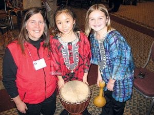 Sawtooth Mountain Elementary music teacher Ann Russ and two young friends at the West African drumming session during the Minnesota Music Educators Association conference in February 2010.