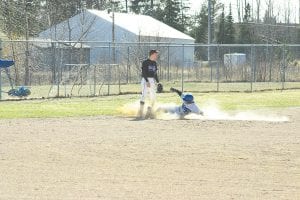 The Vikings shut out the Babbitt-Embarrass Knights, 10-0, in five innings on Friday, April 16. Above: Freshman Luke Fenwick slides to third. Fenwick also played well at bat, earning three RBIs. Right: Pitcher James Groth gave up only one hit in five scoreless innings on the mound.