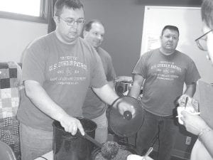 Bottom: The Border Patrol cooked up a wild chili with moose and venison in it. (L-R) Mariano Arguedas, Aaron Logan, and Rich Fortunato