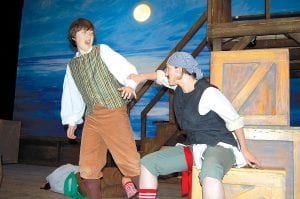 Everyone loved the adventurous Playhouse production of Treasure Island! The crew has sailed off into the sunset, but they will be back at the end of June. If you missed the action, you’ll get a second chance! Here, Jim Hawkins (Sean MacDonell) wrestles free from Israel Hands (Sarah Warren).