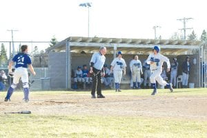 Above: Freshman Kale Boomer coming home after some exciting base-stealing action. Right: Sophomore Dylan Quaife had a good game on both sides of the ball on Tuesday, April 27, at bat and starting on the mound.