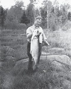 This photo, from the Minnesota Historical Society collection, shows a happy fisherman from the 1940s. The picture in annotated N. N. Nadeau, Minneapolis photographer, with a 28½ pound Lake Superior trout caught at Nanaboujou [sic] Lodge, Grand Marais.