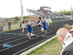 The second outdoor Track meet of the season was held in Two Harbors on May 4. Above: Jordan Zunker hands off to Bjorn Johnson in the relay. Left: Lars Scannell out of the starting blocks in the 200.