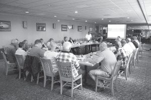 Twenty-one county commissioners from seven northeast Minnesota counties gathered at Island View Restaurant in Grand Portage on Friday, May 21, 2010 for an Association of Minnesota Counties district meeting. Cook County board chair Fritz Sobanja said, “Grand Portage, I think, is one of the most beautiful places in the world.” Norman Deschampe, tribal council chair and president of the Minnesota Chippewa Tribe, welcomed the visitors and thanked them for coming. “We have a very good relationship with our county commissioners,” he said. “We appreciate that.” Left: Tribal elder Billy Blackwell offered an opening prayer and invited others to join him. “I will be asking for strength [and] wisdom to do the best you can to help your people,” he said. He asked for the Great Spirit to give a good life to all human beings. “What is happening in the future, I don’t know,” he said. “Hopefully, we can get through what’s coming ahead in time.” He marveled at the history of the area, noting a discovery of cone-shaped copper goggles dating back an estimated 6,000 to 7,000 years.