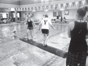 Jessica Berg-Collman (left) of Grand Marais competing in the Rusty Ankle Log Rolling Tournament recently held in LaCrosse, Wisconsin. Jessica took home the second place medal in a very close championship match.