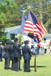 As they always do, American Legion Post 413 members took time out of their Memorial Day weekend to honor their comrades at a ceremony on the Cook County courthouse lawn. Above left: Cook County High School band member Shelby Ahrendt echoed the notes of Taps played by fellow bugler Lars Scannell. Above right: Grand Marais Mayor Sue Hakes thanked veterans and urged those in attendance to become better citizens. She said, “Let’s support our veterans through action.”