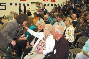 Ethel Johnson and Paul Johnson flank Mabel Stolz who is talking to CCHS principal Gwen Carmen. Stolz was introduced as Cook County’s oldest known living high school graduate at last week’s commencement exercise. She was given a standing ovation.