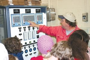 Above, Grand Marais Public Utilities water plant operator Neil Hansen gave 4th & 5th grade Sawtooth Elementary students a tour of the fresh water plant located in the tourist park. Fifth grade teacher Julie Viren stands with some of her students inside the plant last Wednesday during a tour of the facilities. Students walked throughout town taking in different venues and sites of town.