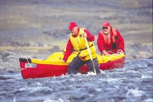 Top: Minnesota’s Bob O’Hara (in back with sunglasses) is considered one of the greatest arctic canoeists of all time. Here he and his buddy, Ken push their canoe up a stretch of whitewater on a far north Canadian river. O’Hara is the Boat Show’s keynote speaker. Above: Not many have paddled the Arrowsmith River, which empties into the Arctic Ocean. But Bob O’ Hara accomplished the feat in 2005. Here he holds his “First Decent” bib he was given for accomplishing this difficult paddle. Left: Also speaking is Paul Danicic who will share the story of the “Canoe the Heart” expedition.