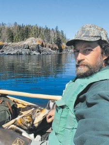 Eric Simula on the water in his handcrafted birch bark canoe.